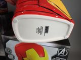 a red and yellow iron man helmet sitting on top of a box