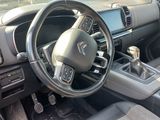 a dashboard of a car with a steering wheel and dashboard controls
