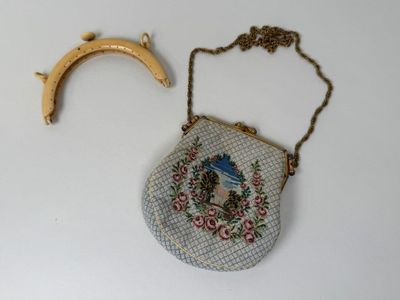 a small purse with a gold handle and a small purse with a gold handle