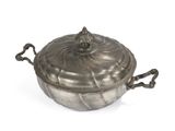 an antique silver plated casserole with handles on a white background