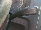 a dog sitting in the driver seat of a car