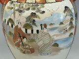 a large vase with a painting on it on a table