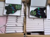 two boxes of socks that are on top of each other