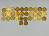 a close up of a pile of gold coins on a white surface