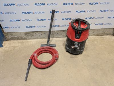 an image of a red vacuum and a red hose on the floor