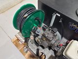a picture of a green hose and a green reel