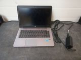 a laptop that is sitting on the floor next to a charger