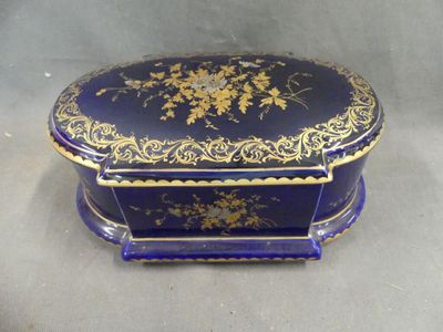 an image of a blue and gold box with flowers on it