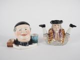 pair of ceramic figurines of two men with hats and tails