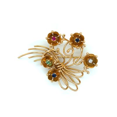 yellow gold plated brooch with multi colored stones on it