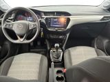 the interior of a small car with a steering wheel and dashboard