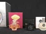 three different perfumes and a clock on a table