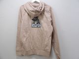 the back of a tan sweatshirt with a black and white logo on it
