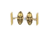 a close up of a pair of gold cufflinks on a white background