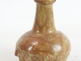 a small brown vase sitting on a white surface