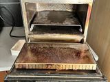 three ovens stacked on top of each other in the kitchen