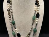 a close up of a necklace on a mannequin mannequin