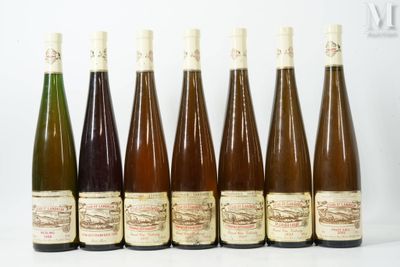 six bottles of wine are lined up in a row on a table