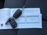 a car key sitting on top of a book on a car seat