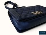 an image of a blue handbag with a metal handle