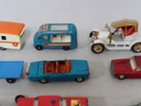 several toy cars are lined up in a row on a white surface