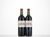 two bottles of wine sitting on top of a table next to each other