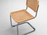 an image of a chair with a wicker seat and a metal frame