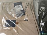 two pairs of pants that are wrapped in plastic