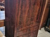 a very large wooden cabinet in the middle of a room