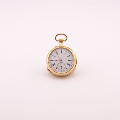 a close up of a gold pocket watch on a white surface