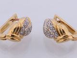 a pair of gold and diamond earrings on a white background