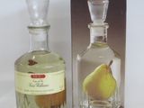 a bottle of perfume with a pear on it next to a box