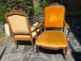 two chairs sitting next to each other on a stone patio