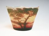 a glass vase with a picture of a tree on it