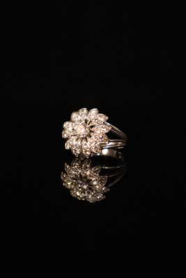 a close up of a diamond ring on a black surface