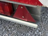 a close up of the rear end of a red truck