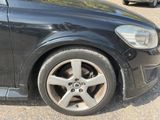 a black car that is parked on the side of the road
