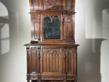 a wooden cabinet with a mirror on top of it