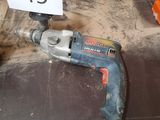 a drill and a sign on the floor in a room
