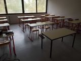 many tables and chairs in a room with a big window