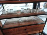 a display case with a lot of empty glasses on it