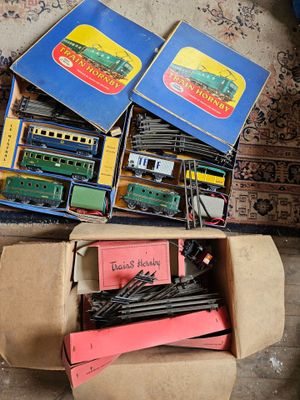 a box full of toy trains sitting on the floor