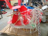 a red chair sitting on top of a pallet in a warehouse