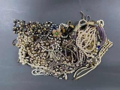 a pile of assorted beads and jewelry on a table