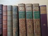 many old books lined up on a shelf