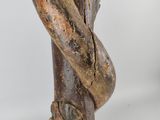 wooden sculpture of a snake wrapped around a branch on a white background