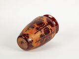 a brown vase with a design on it on a white surface