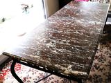 a table with a marble top in front of a window