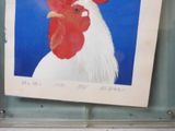 a picture of a rooster on display in a glass case