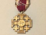 an image of a gold medal with a red ribbon on a white surface
